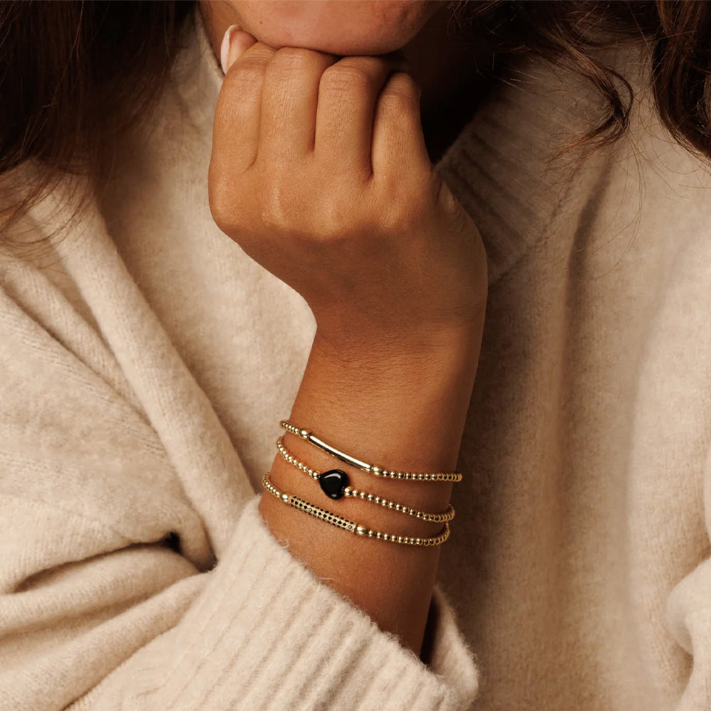 my bendel armbanden in goud en met zwart hartje